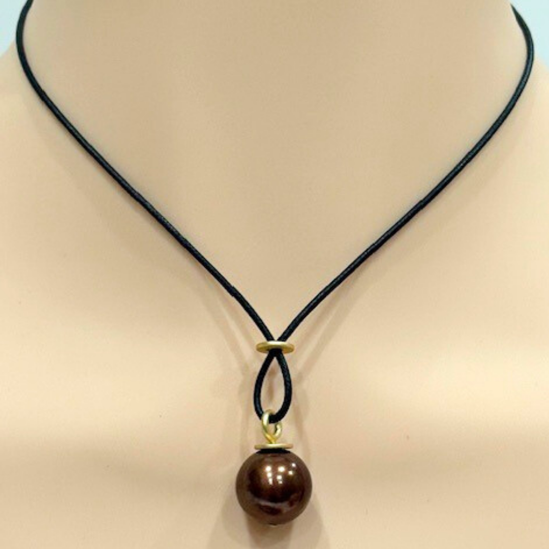 Large Chocolate Color Pearl With Criss Cross Design On Black Linen Cord