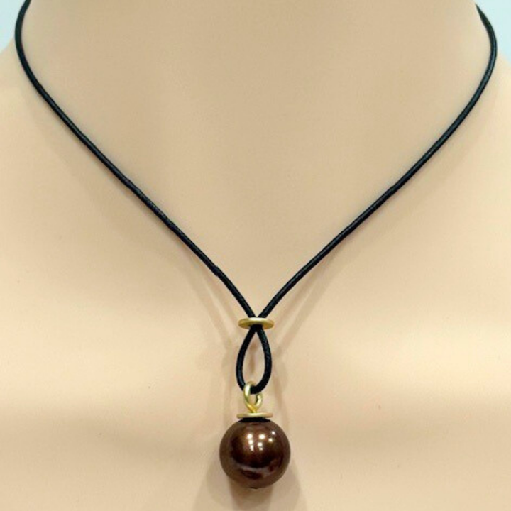 Large Chocolate Color Pearl With Criss Cross Design On Black Linen Cord