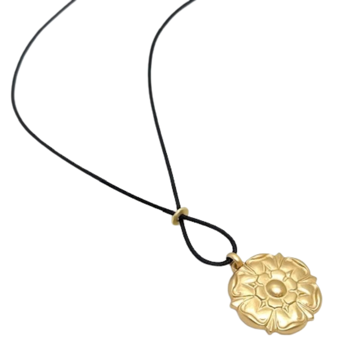Matte Gold Starburst Pendant And Black Linen Cord Criss Cross Design Necklace
